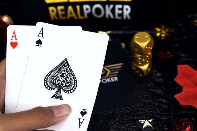 A player showing two 'As' cards in poker 