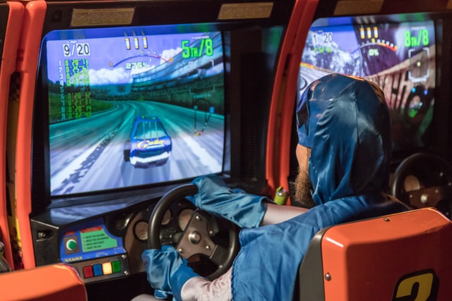 A person playing a racing game in the gaming arena