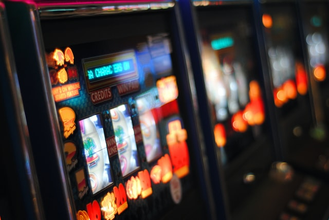 A person putting money into the slot games to win big prizes
